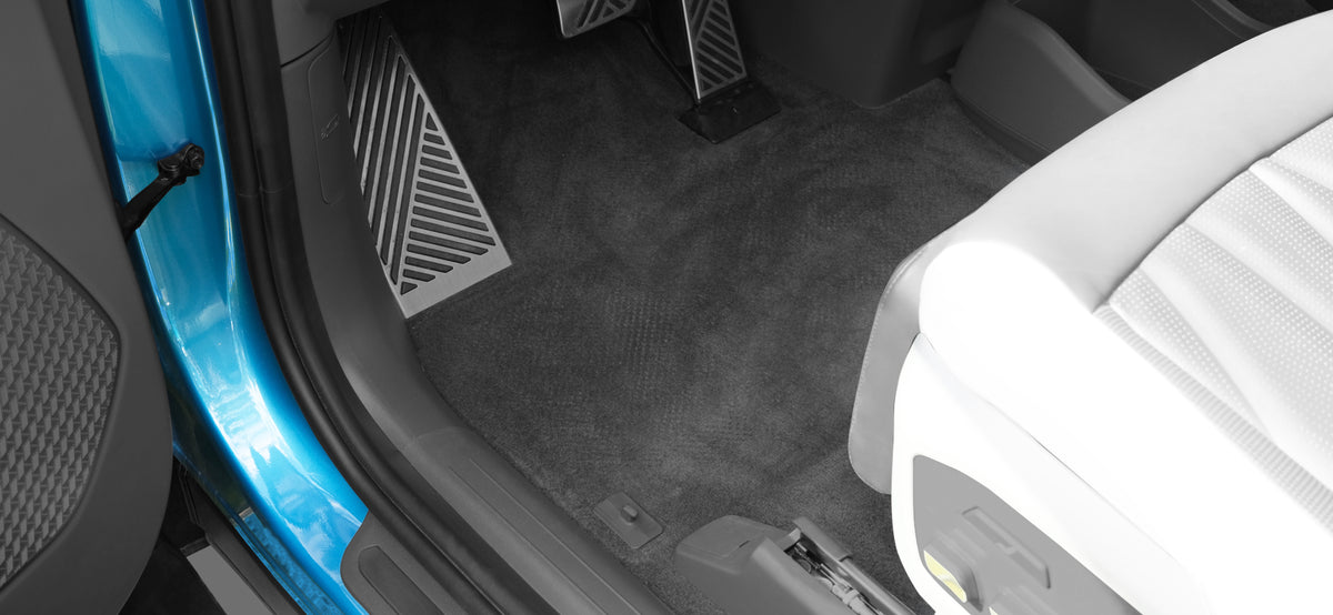 The same vehicle footwell showing the original carpet without LinerX