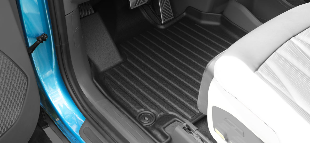 Vehicle footwell with a fitted LinerX floor mat covering the carpet